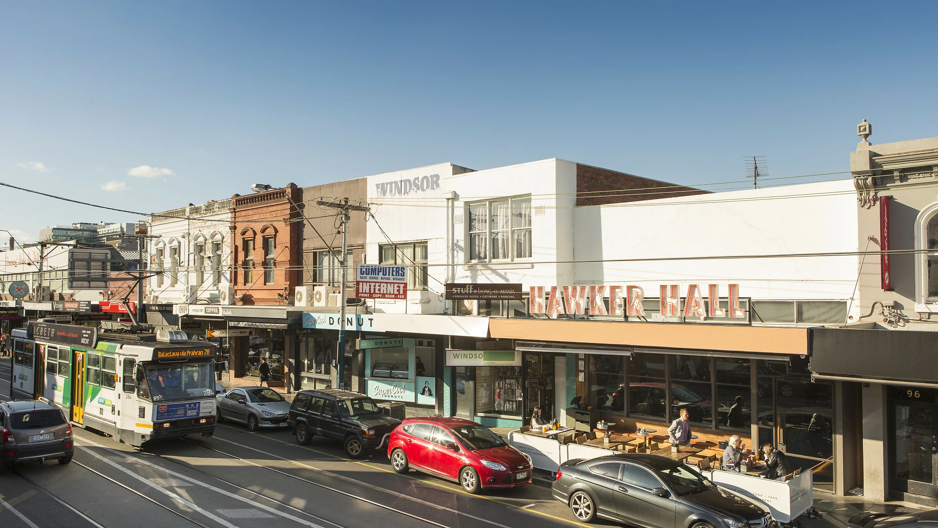 Tram passing Chapel Street shopfronts in Windsor