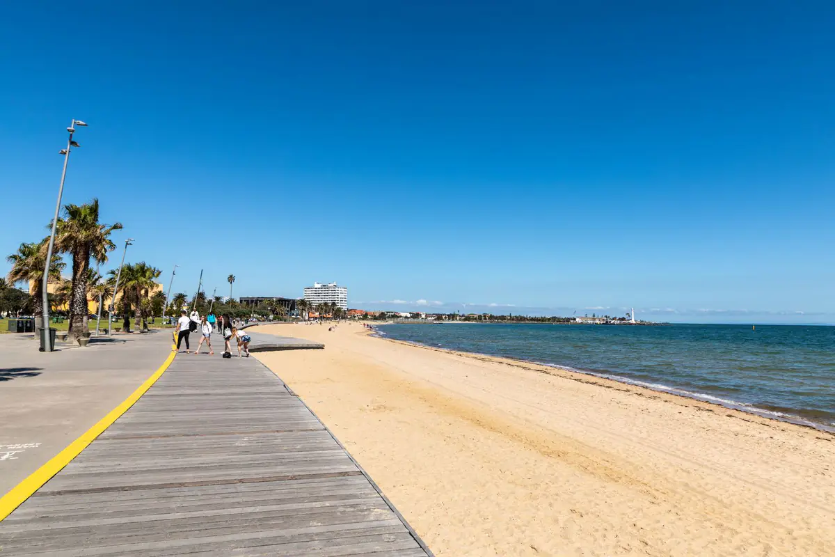 Beachfront boardwalk, sand and Port Phillip Bay at St Kilda Beach