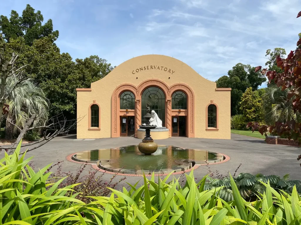 Peach-coloured Conservatory and fountain in Fitzroy Gardens, East Melbourne