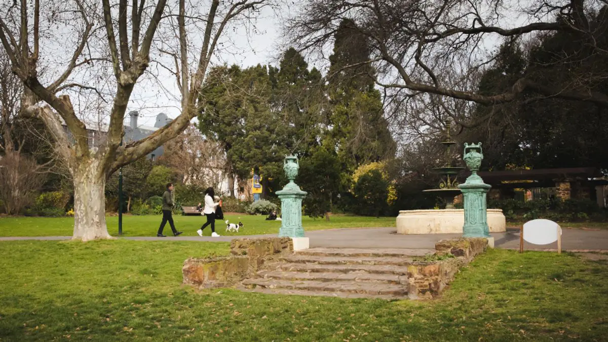 Stone steps, ornamental urns and mature trees in Victoria Gardens, Prahran