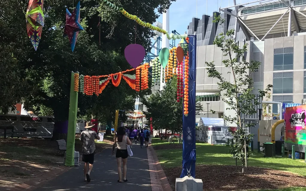 People walking through Yarra Park beside the MCG